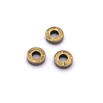 Kerek, lapos köztes dísz, bronz szín, 6x2 mm, 10 db