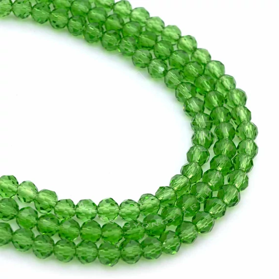 Kristály fazettált button szál, lime zöld, 4x3 mm, kb. 40 cm, 123-127 szem/szál